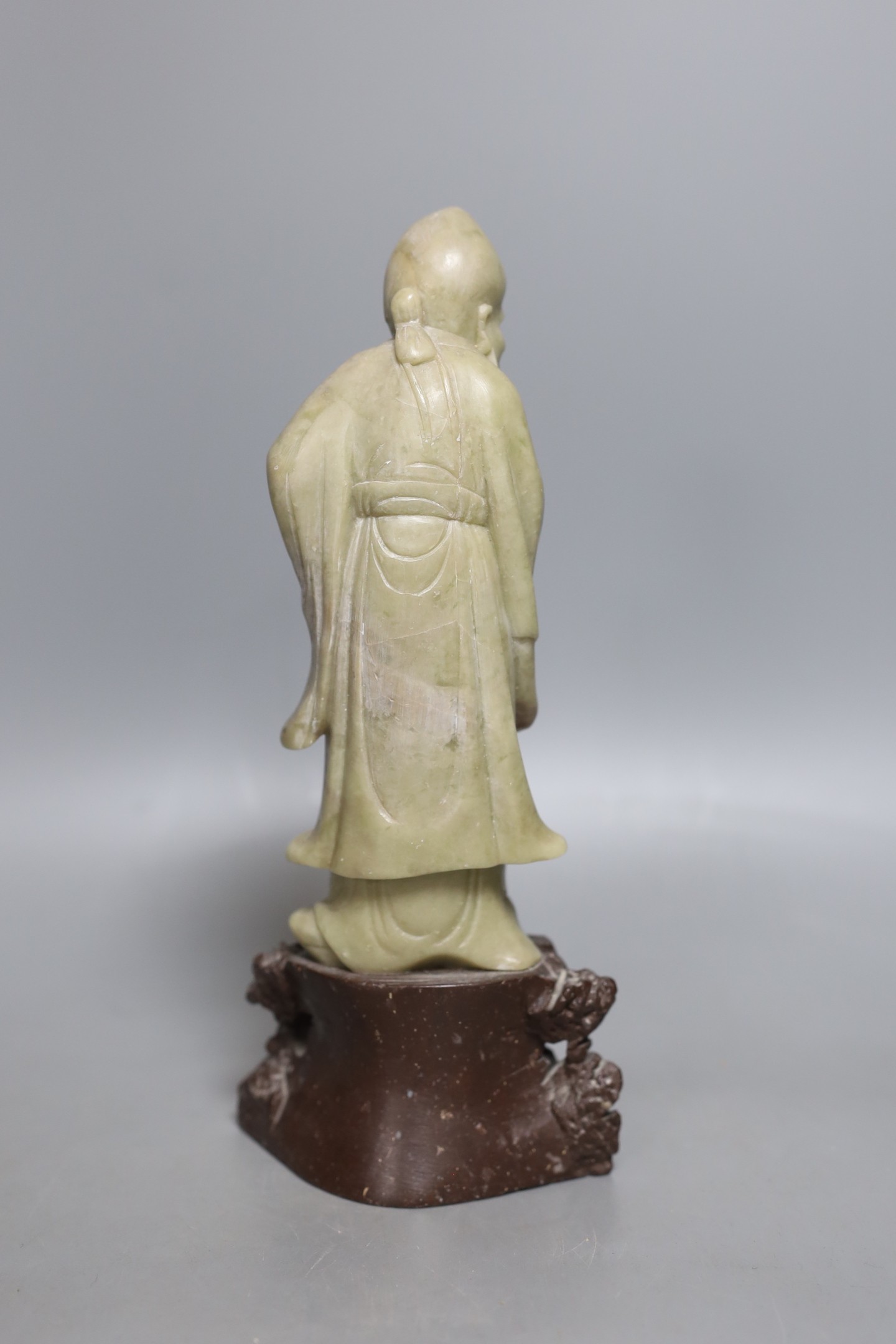 An early 20th century Chinese carved soapstone model of a sage - 23.5cm tall